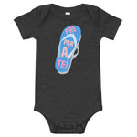 prepárate on a chancleta on a charcoal gray onesie